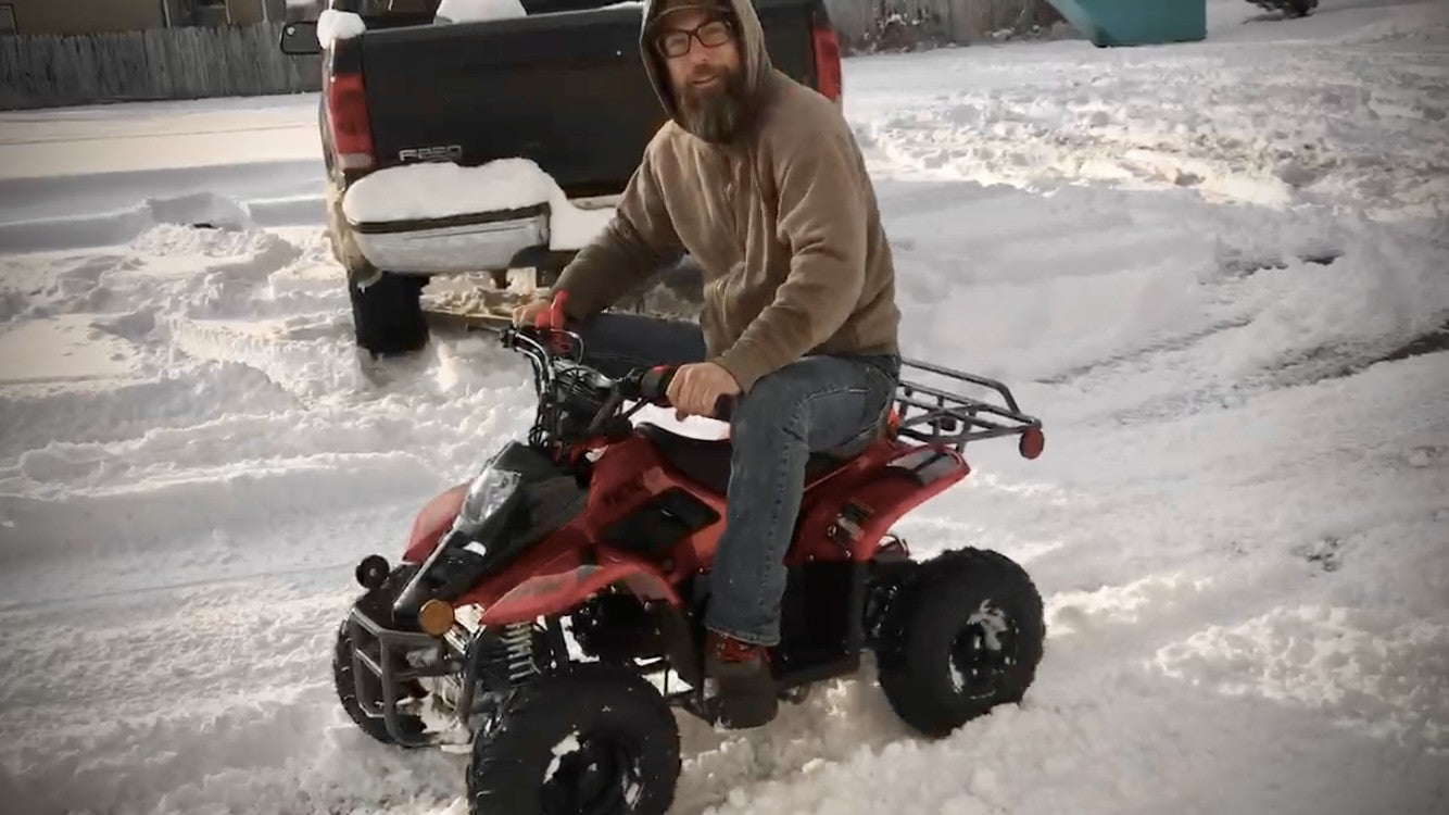 kids ATV riding in the snow